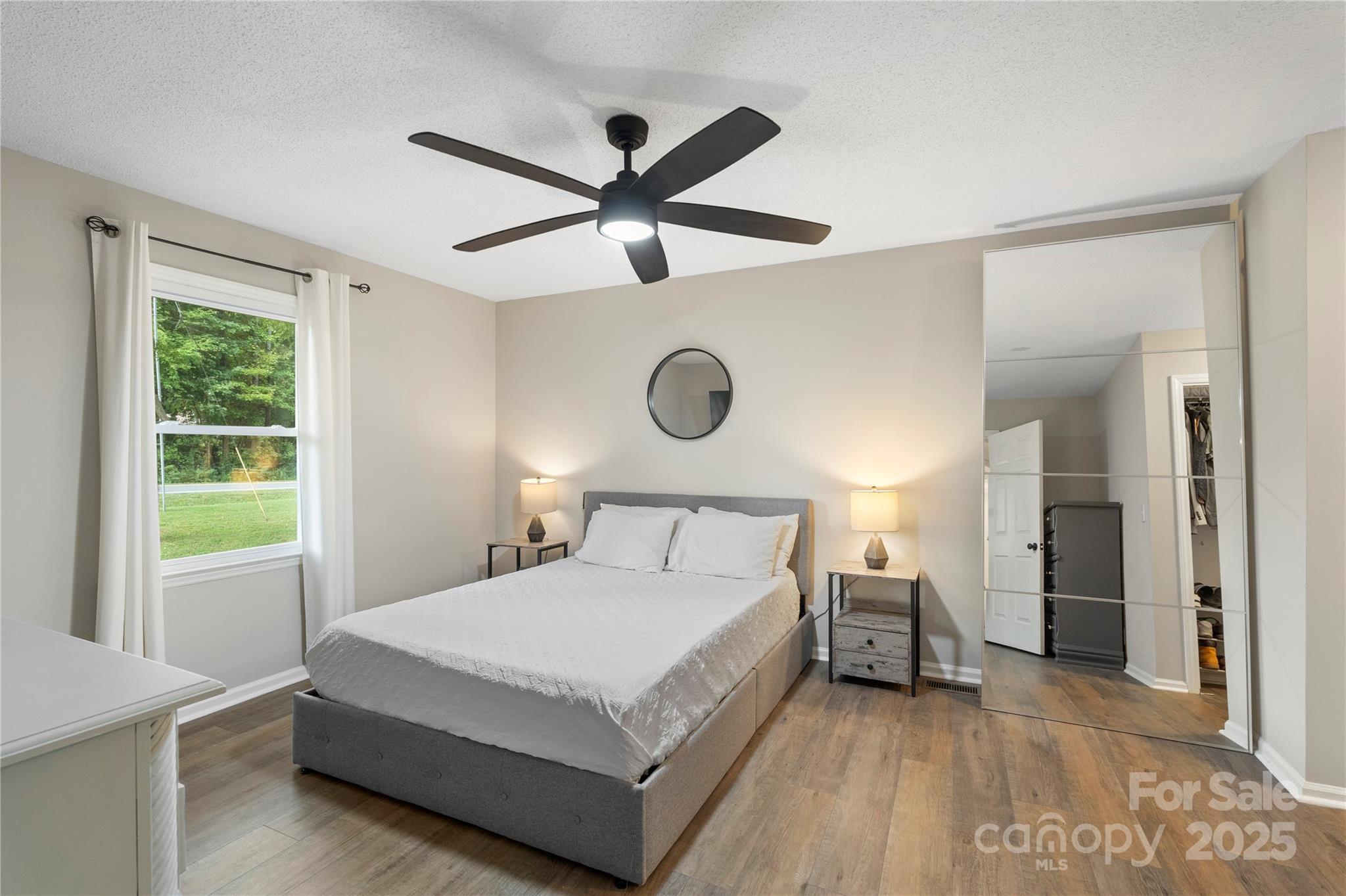 2302 Old Hickory Grove Road Mount Holly, NC 28120 - Photo 21 of 48 a bedroom with a large bed and a chandelier