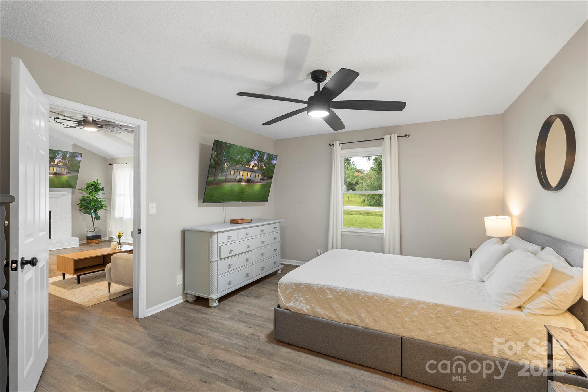 2302 Old Hickory Grove Road Mount Holly, NC 28120 - Photo 22 of 48 a bedroom with a large bed and a chandelier