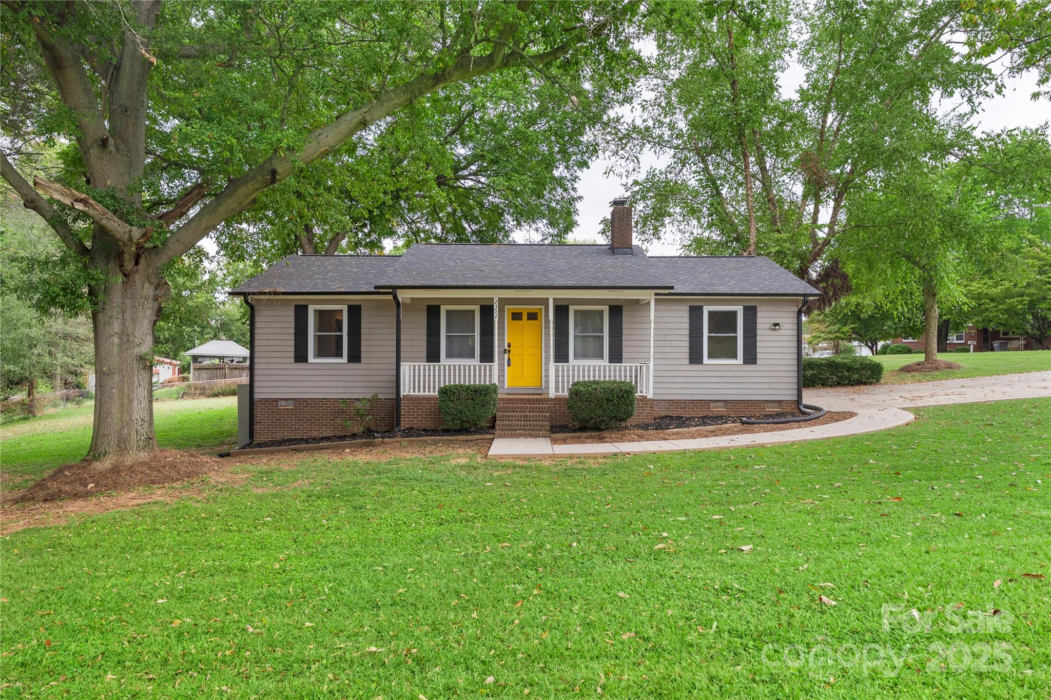 2302 Old Hickory Grove Road Mount Holly, NC 28120 - Photo 3 of 48 a front view of house with a garden and trees