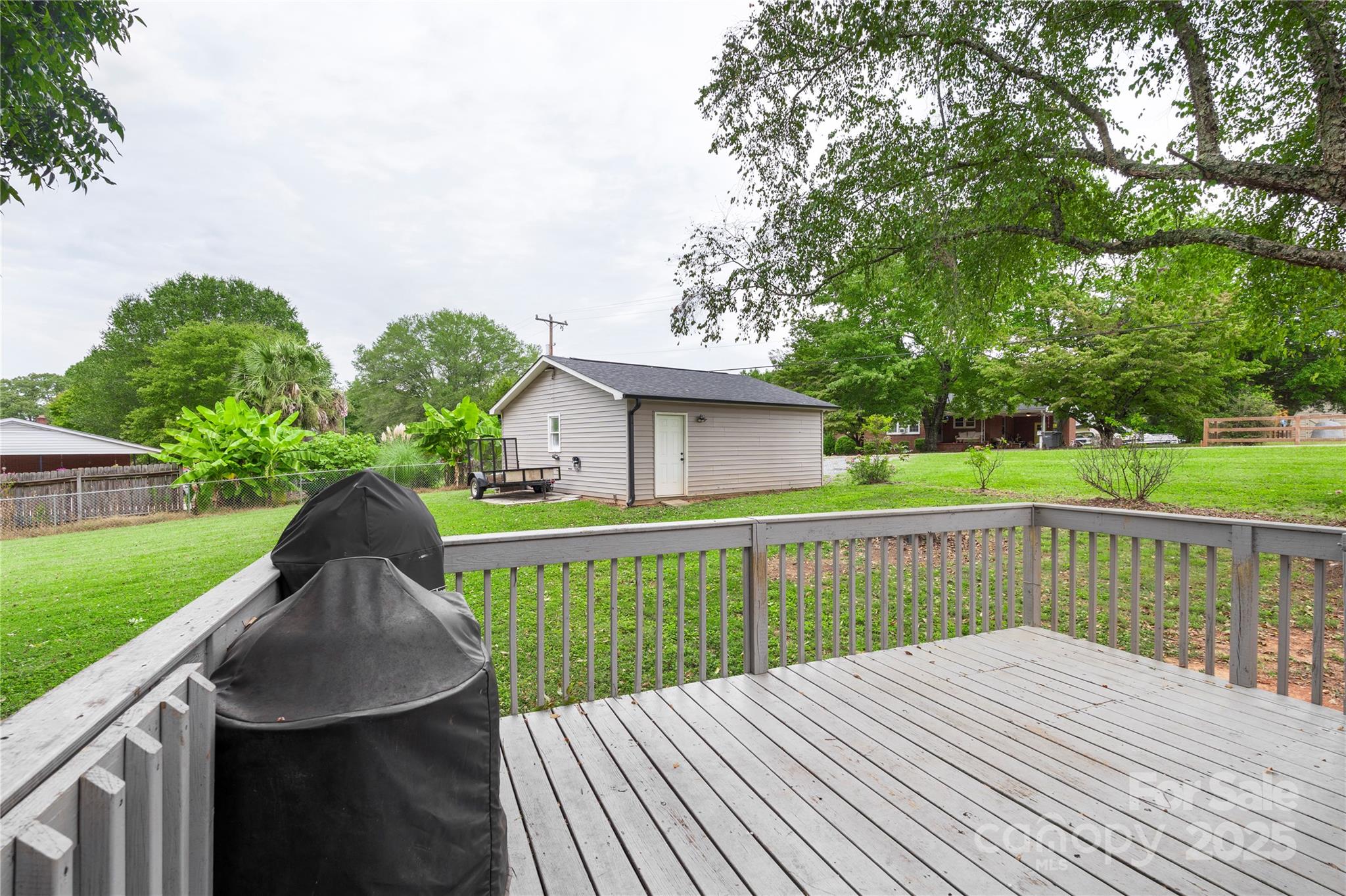 2302 Old Hickory Grove Road Mount Holly, NC 28120 - Photo 38 of 48 a view of a wooden deck and a yard