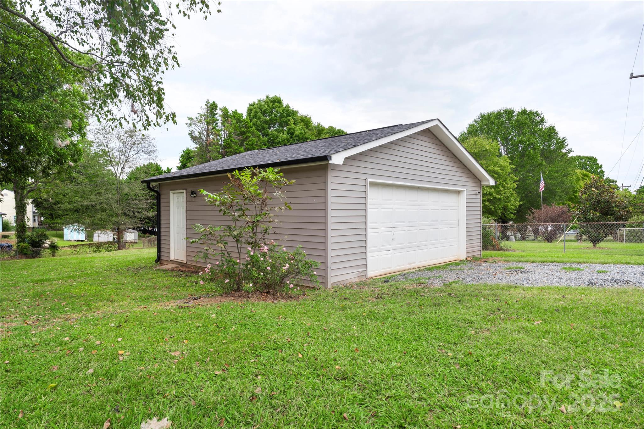 2302 Old Hickory Grove Road Mount Holly, NC 28120 - Photo 40 of 48 a backyard of a house with plants and large tree