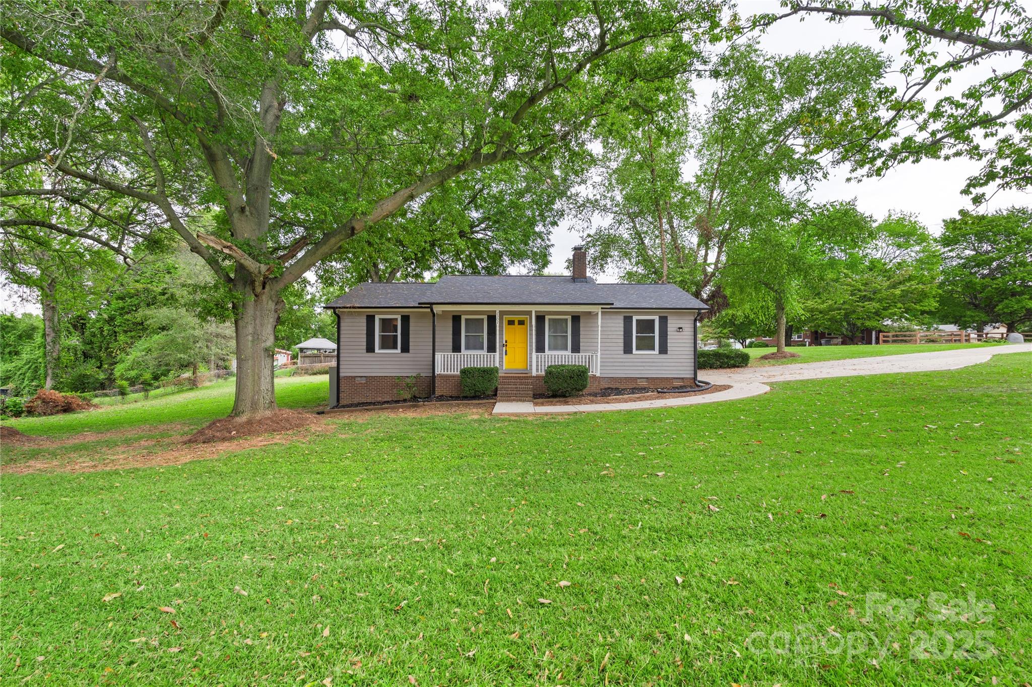 2302 Old Hickory Grove Road Mount Holly, NC 28120 - Photo 5 of 48 a front view of a house with yard porch and green space