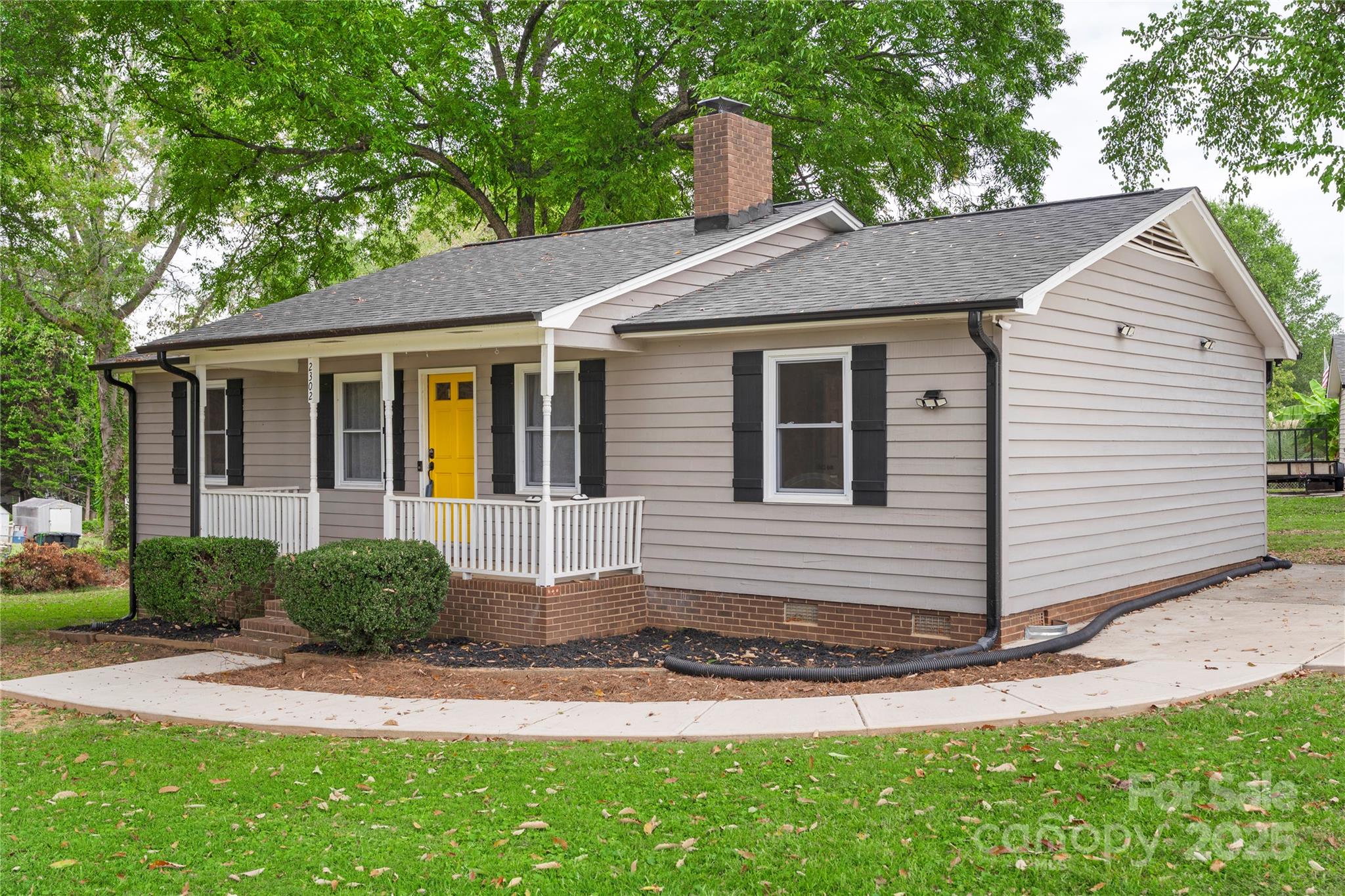 2302 Old Hickory Grove Road Mount Holly, NC 28120 - Photo 7 of 48 a front view of a house with a yard