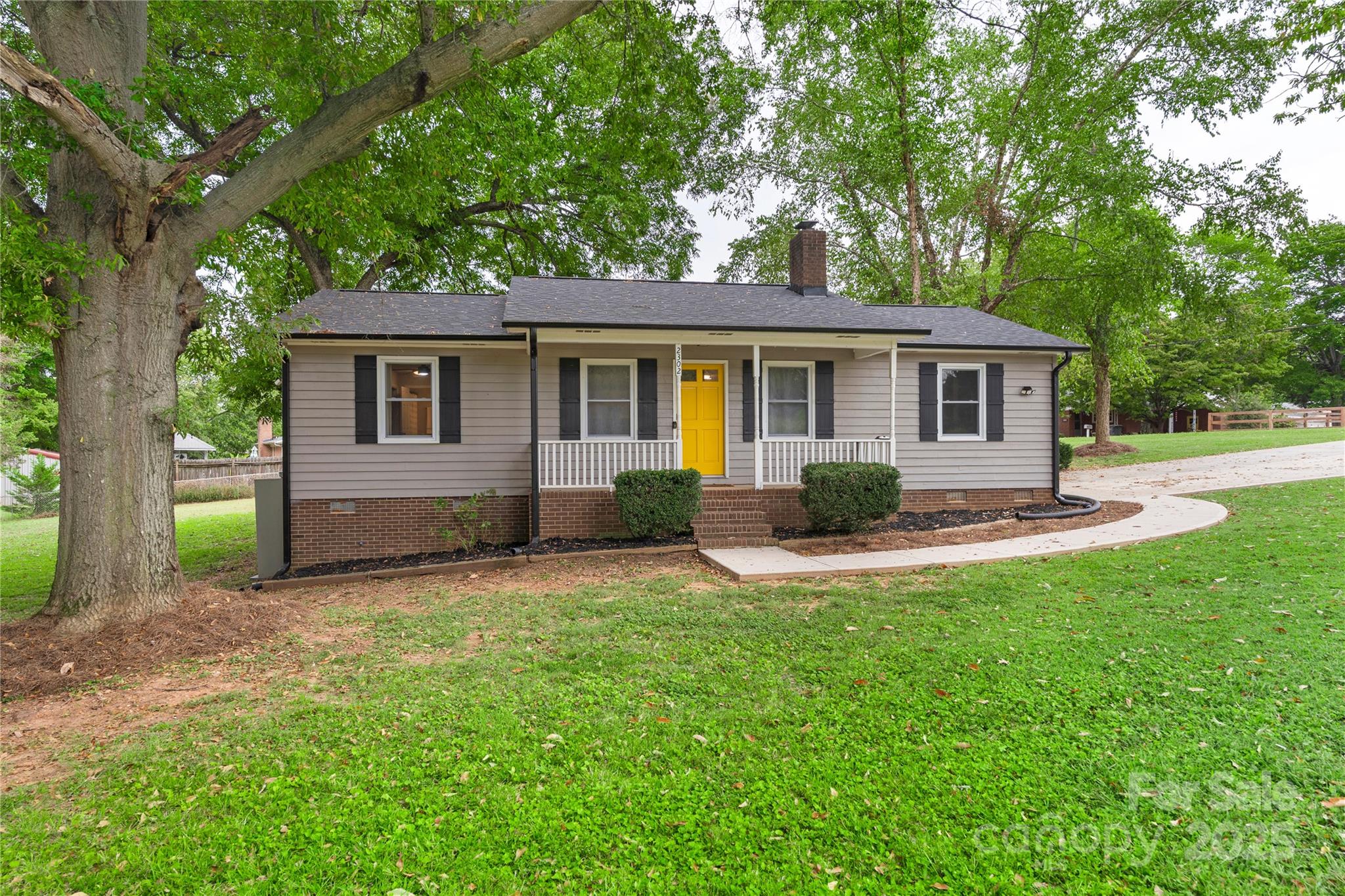 2302 Old Hickory Grove Road Mount Holly, NC 28120 - Photo 8 of 48 a view of a house with a backyard