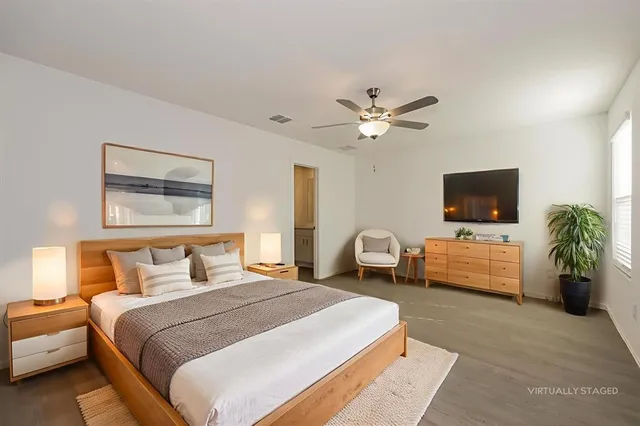 a bedroom with a bed and a flat screen tv