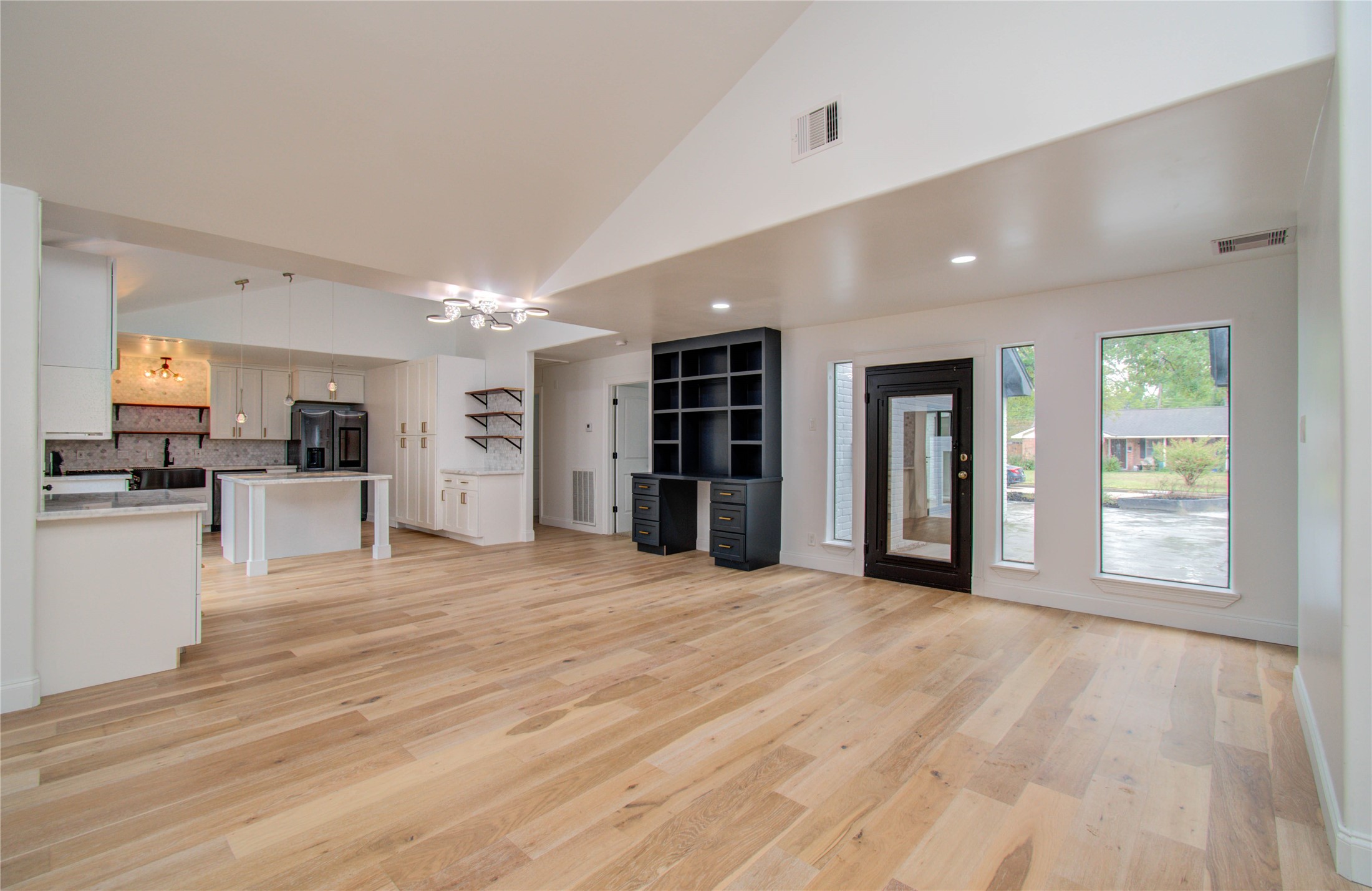 10300 Mayfield Road Houston, TX 77043 - Photo 4 of 32 a view of an empty room with kitchen and window