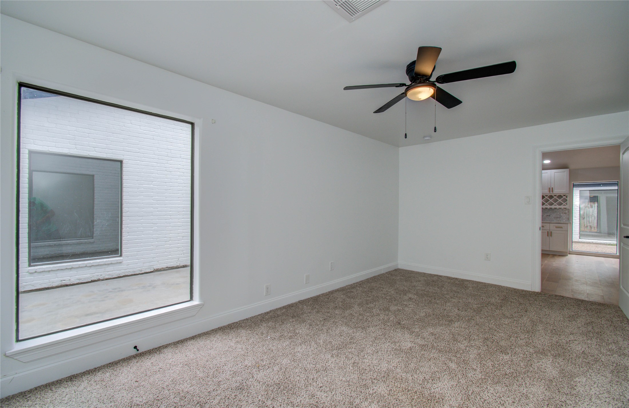10300 Mayfield Road Houston, TX 77043 - Photo 10 of 32 a view of room with a ceiling fan and window