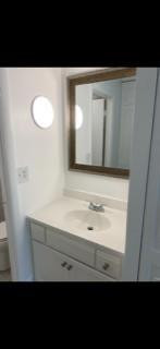 3740 Inverrary Drive, Unit 1A Lauderhill, FL 33319 - Photo 13 of 20 a bathroom with a sink and a mirror