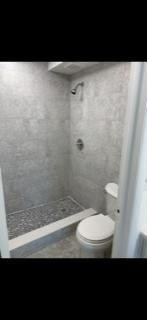 3740 Inverrary Drive, Unit 1A Lauderhill, FL 33319 - Photo 15 of 20 a bathroom with a toilet a sink and shower