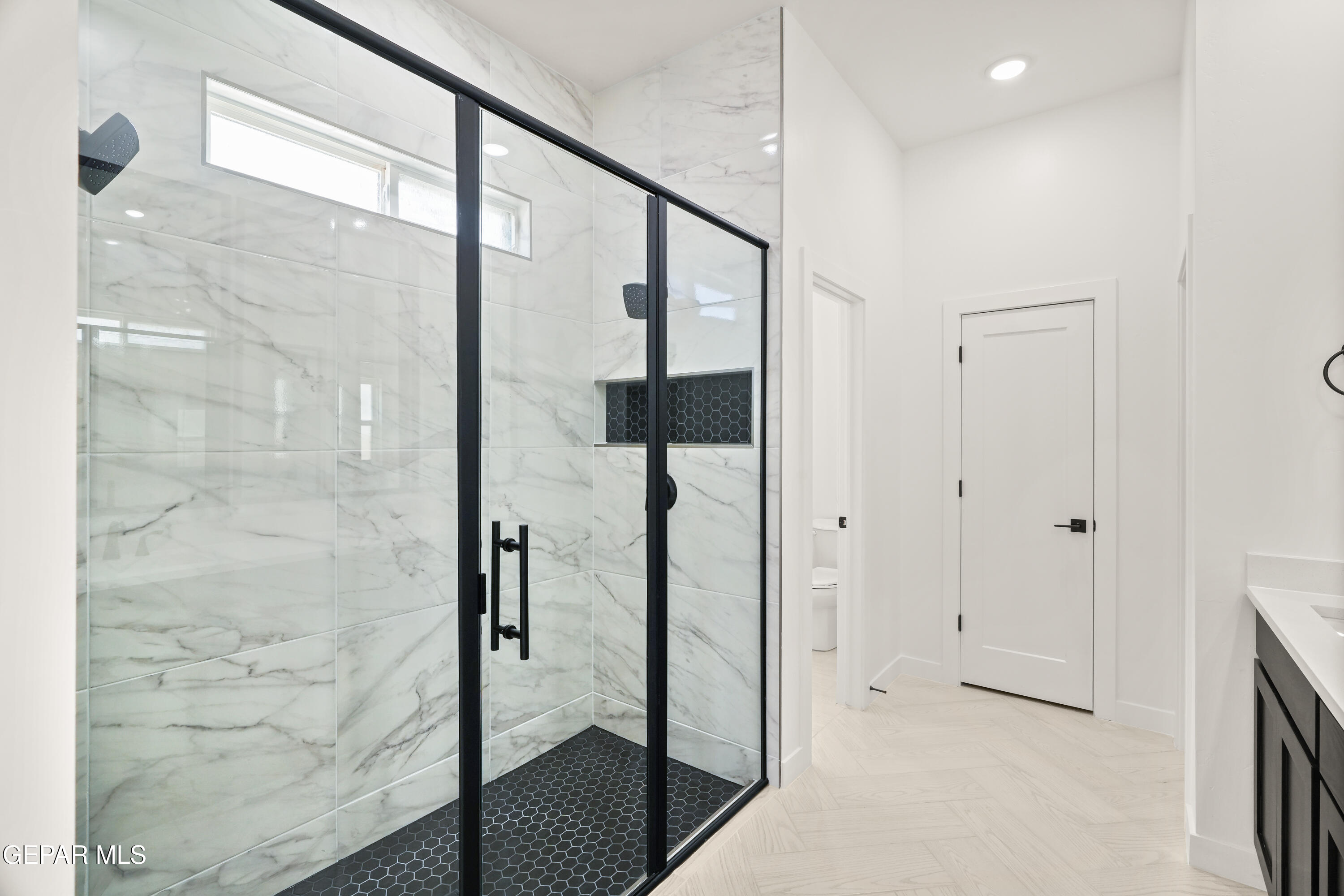 1810 Schyler Love Lane El Paso, TX 79928 - Photo 21 of 37 a bathroom with a glass shower door and a sink