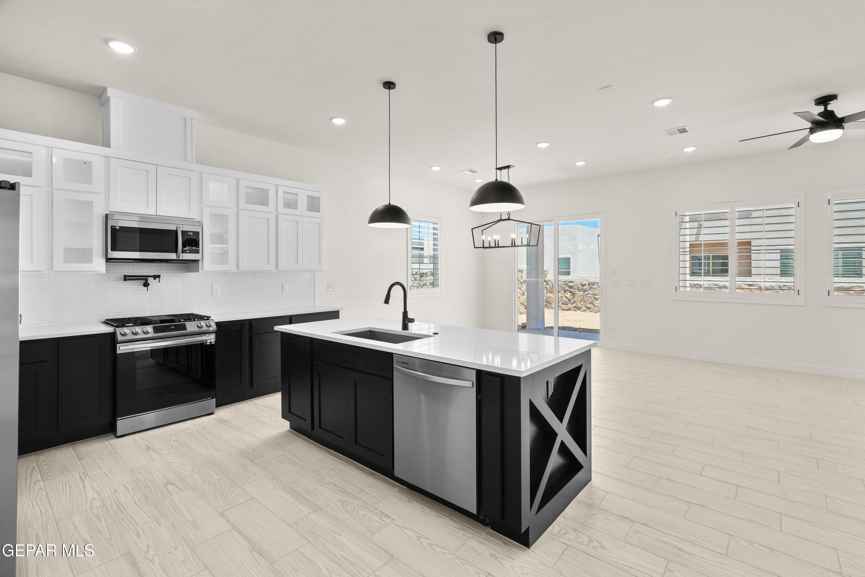 1810 Schyler Love Lane El Paso, TX 79928 - Photo 4 of 37 a kitchen with stainless steel appliances kitchen island a sink stove and microwave