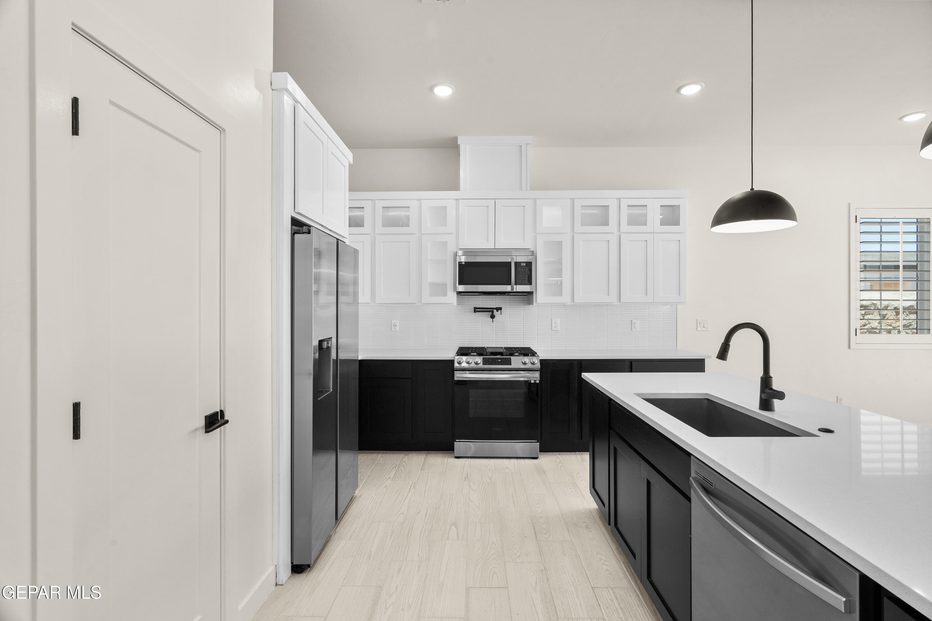 1810 Schyler Love Lane El Paso, TX 79928 - Photo 5 of 37 a kitchen with stainless steel appliances a sink stove and refrigerator