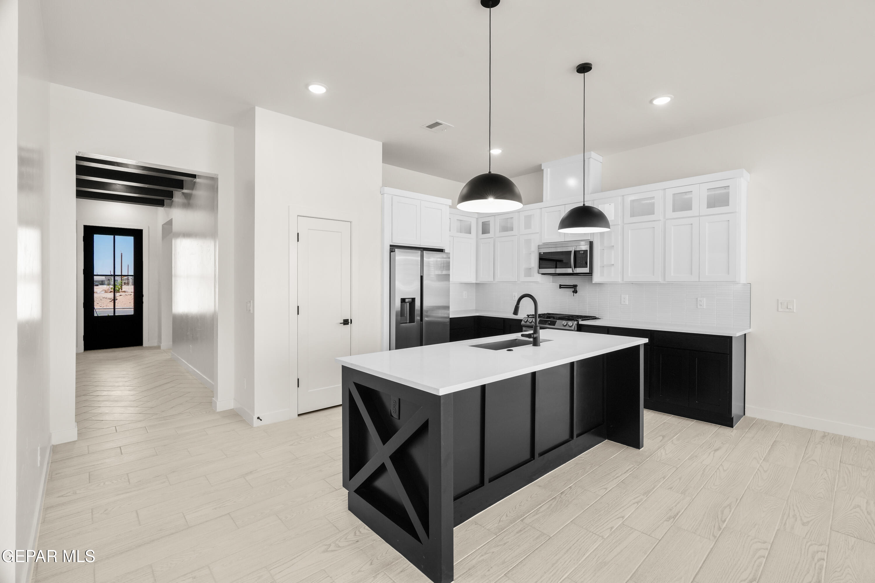 1810 Schyler Love Lane El Paso, TX 79928 - Photo 6 of 37 a open kitchen with a sink a stove and a refrigerator