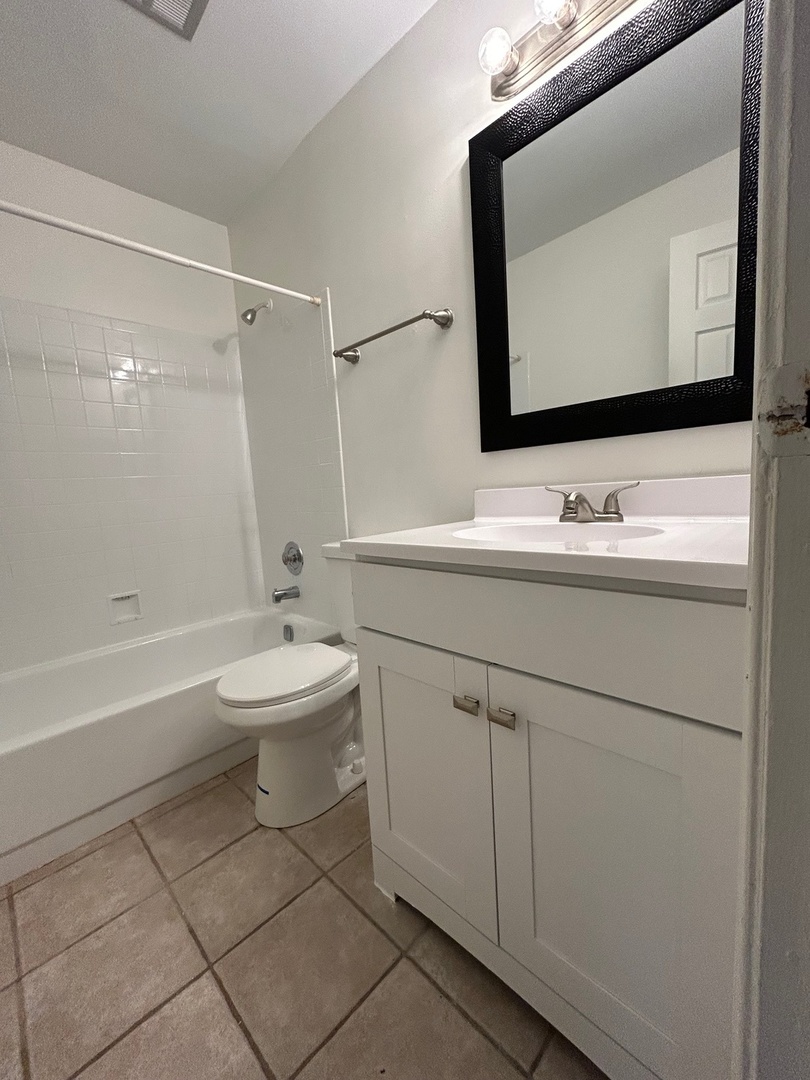 2020 North Rand Road, Unit 109 Palatine, IL 60074 - Photo 8 of 13 a bathroom with a toilet sink and mirror