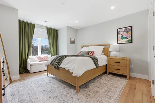 a spacious bedroom with a bed and a couch