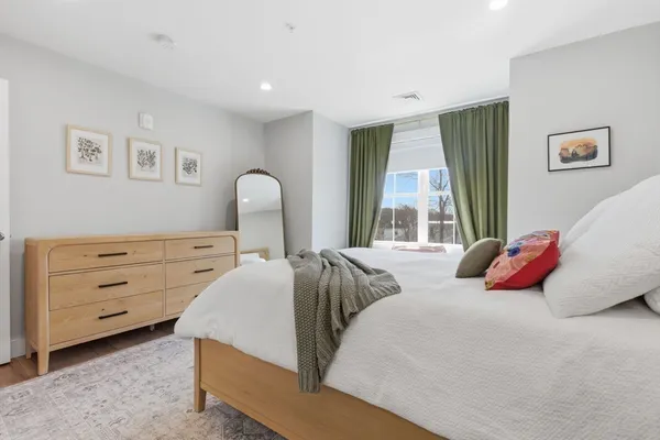 a bedroom with two beds and a large window