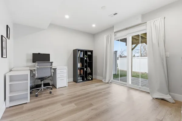 a view of an empty room with a fireplace and a window