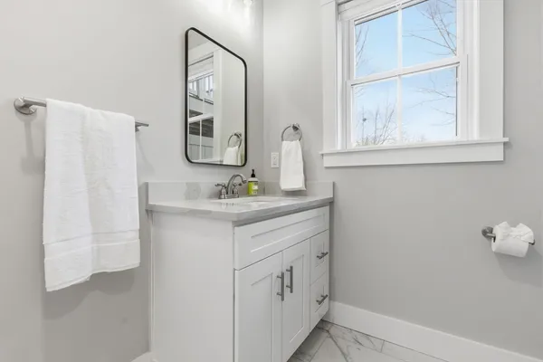 a bathroom with a sink vanity and a mirror