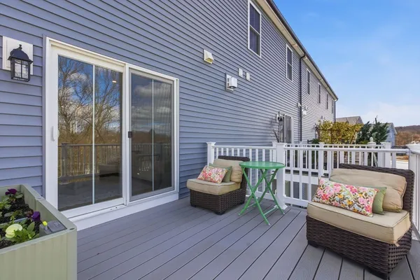 a balcony with wooden floor and furniture