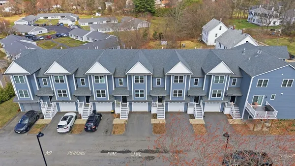 an aerial view of a house with a yard