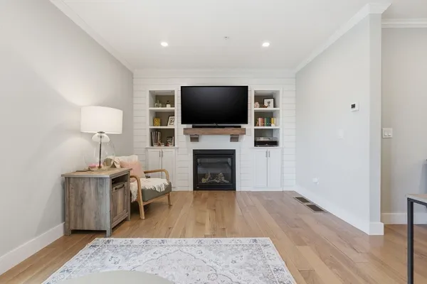 a living room with furniture a flat screen tv and a fireplace