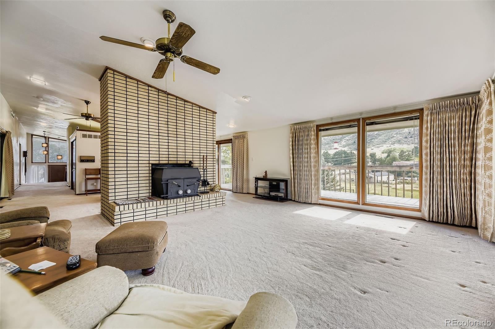 5040 Pine Ridge Road Golden, CO 80403 - Photo 15 of 41 a living room with furniture and a fireplace