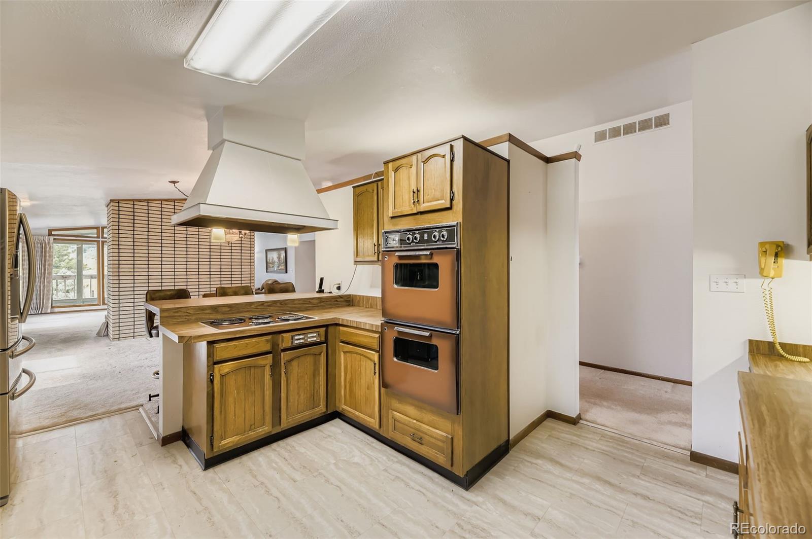 5040 Pine Ridge Road Golden, CO 80403 - Photo 19 of 41 a kitchen with stainless steel appliances granite countertop a stove and a refrigerator