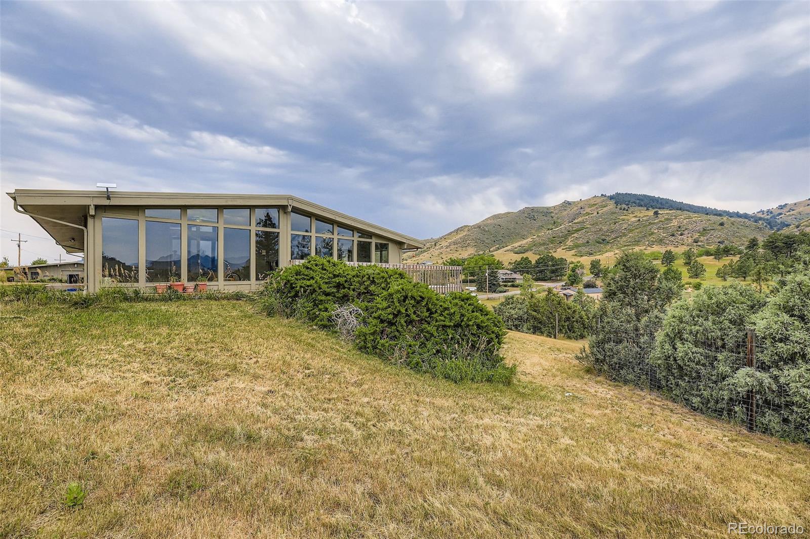5040 Pine Ridge Road Golden, CO 80403 - Photo 2 of 41 a view of a house with a yard and sitting area