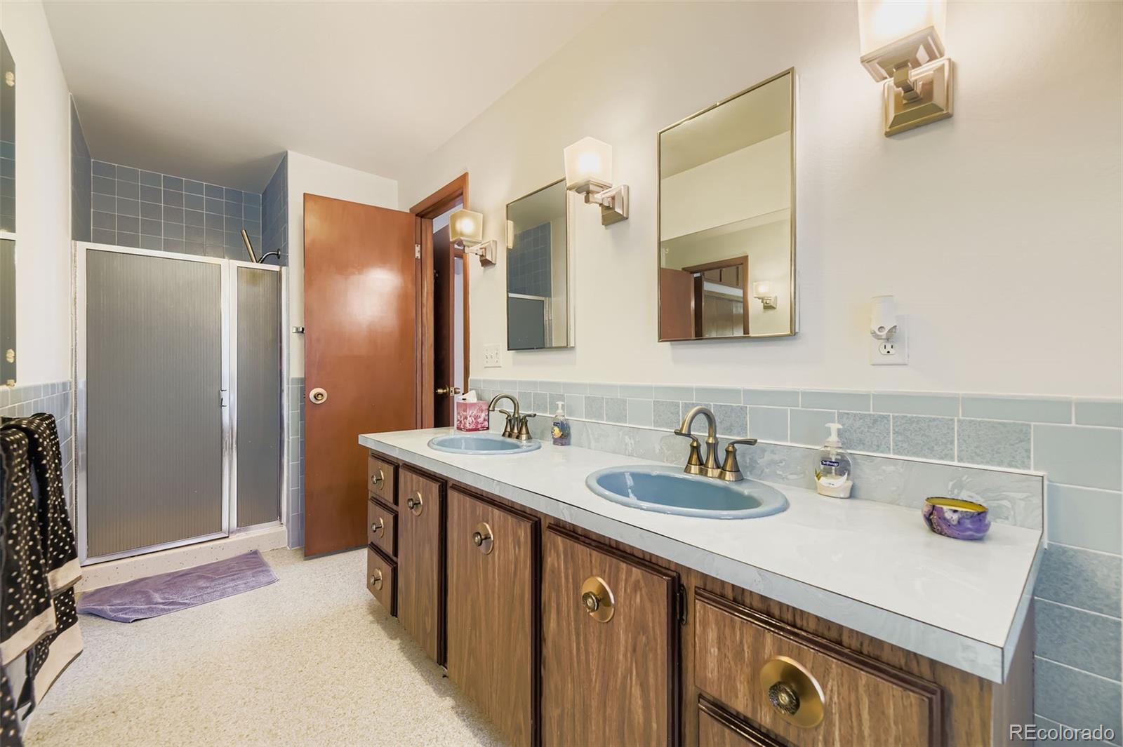 5040 Pine Ridge Road Golden, CO 80403 - Photo 24 of 41 a bathroom with a sink and a mirror
