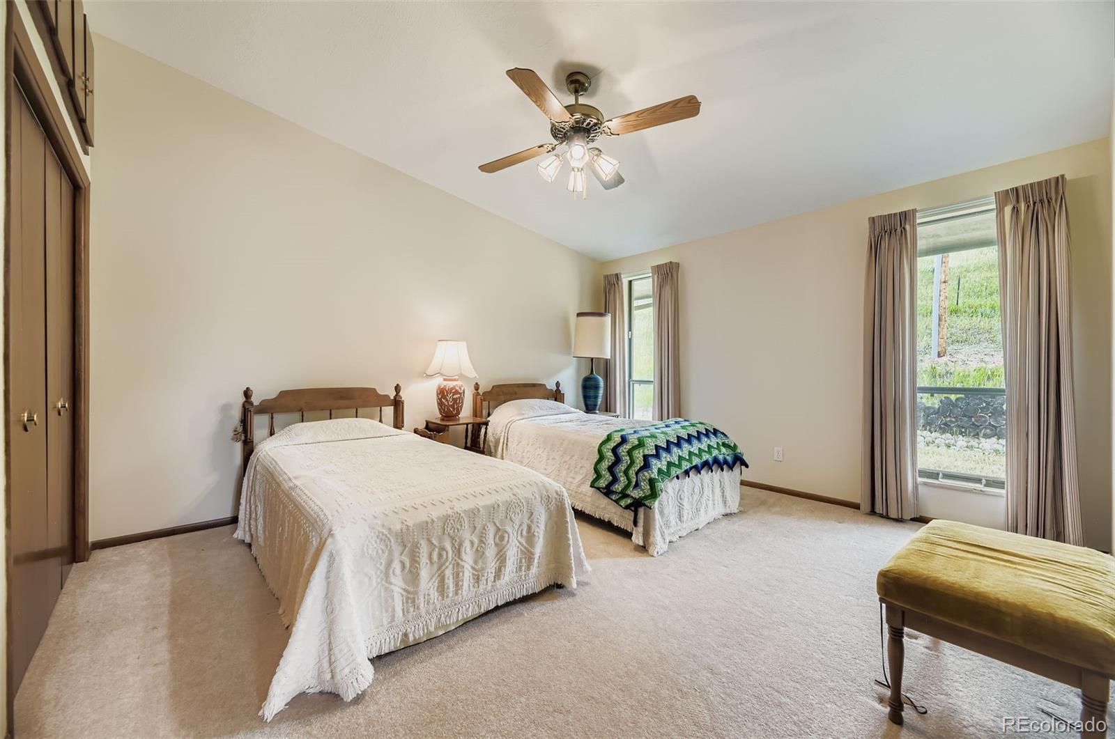 5040 Pine Ridge Road Golden, CO 80403 - Photo 26 of 41 a bedroom with two beds and windows