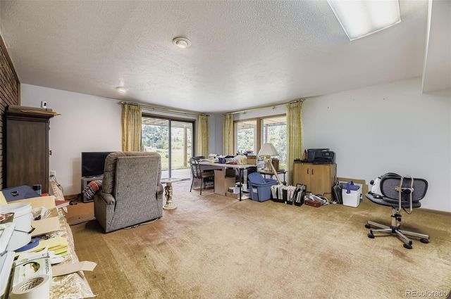 a view of a livingroom with workspace and a couch