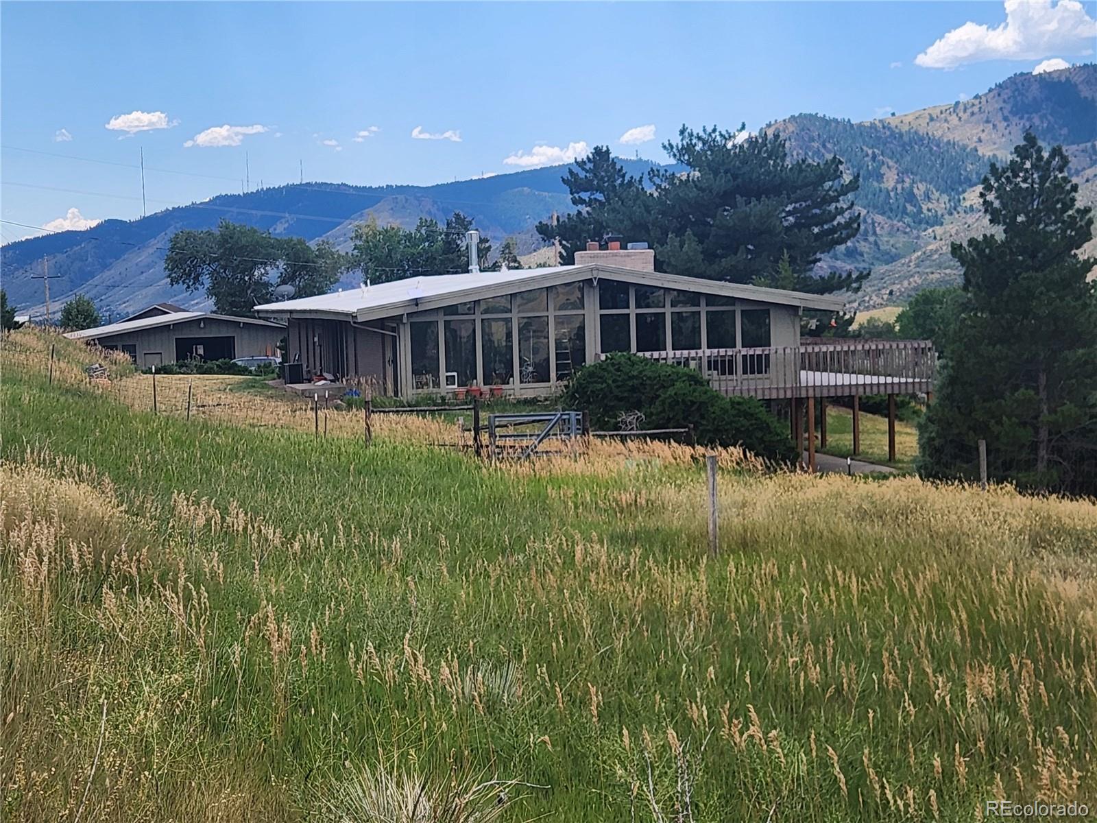 5040 Pine Ridge Road Golden, CO 80403 - Photo 3 of 41 a front view of house with yard and green space