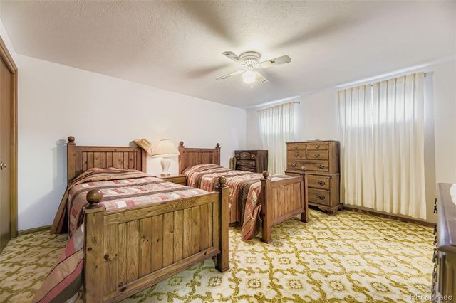 a bedroom with bed and chair