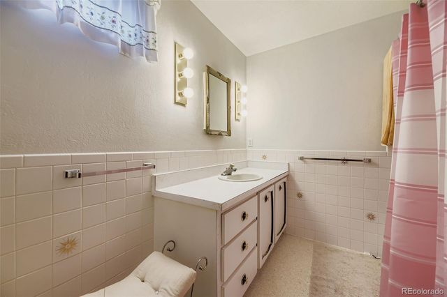 a bathroom with a sink vanity and a shower