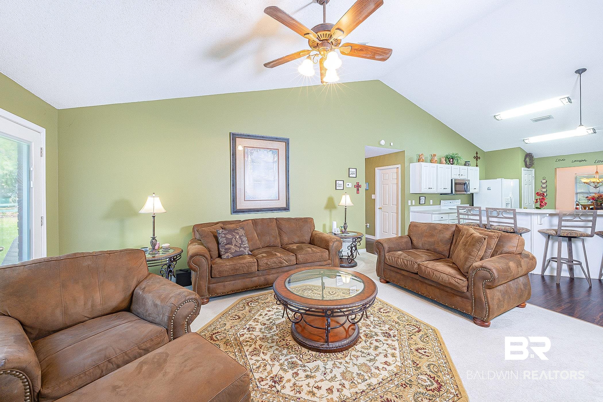 16154 Parke Boulevard Foley, AL 36535 - Photo 9 of 44 Spacious Living room featuring vaulted ceiling, fireplace and ceiling fan