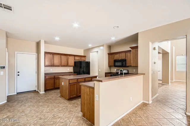 a kitchen with stainless steel appliances a refrigerator and a stove top oven