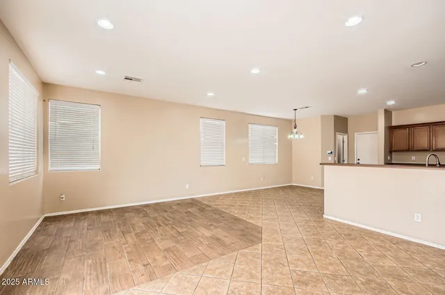 a view of an empty room with kitchen appliances and a window
