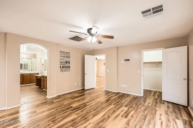 a view of a livingroom with a hardwood floor and a ceiling fan