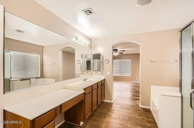 a large bathroom with a double vanity sink and a mirror
