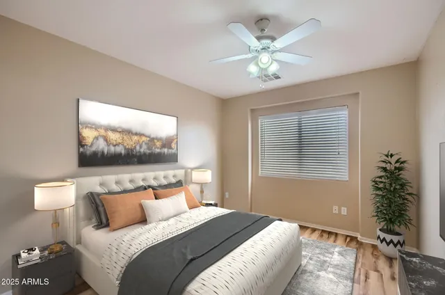 a bedroom with a bed and a chandelier