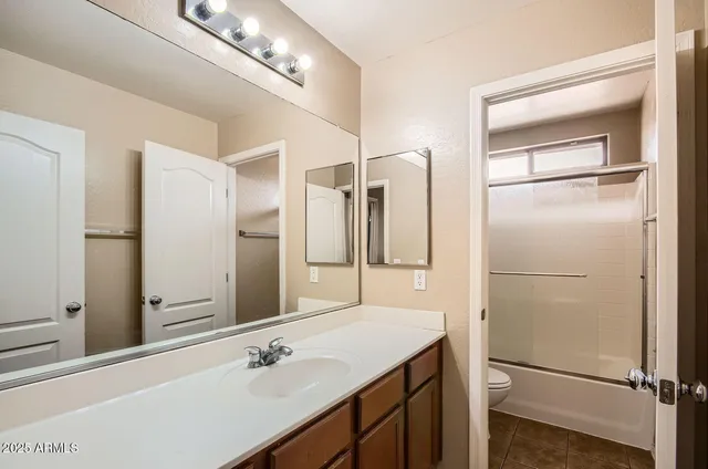 a bathroom with a shower sink and mirror