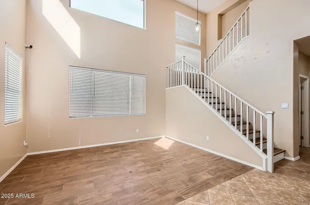 a view of staircase with white walls and a window
