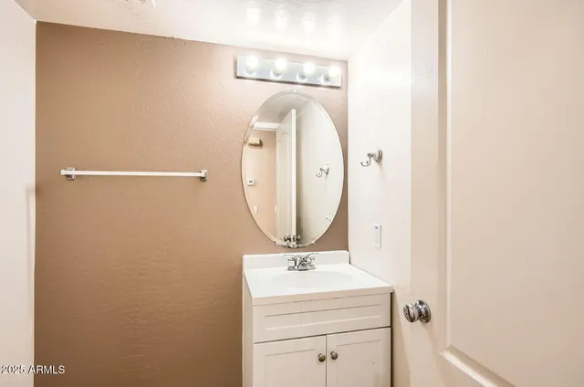 a bathroom with a sink and mirror