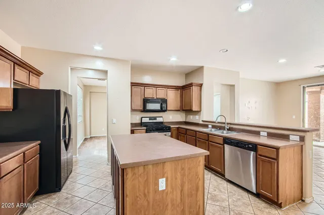 a kitchen with stainless steel appliances a stove sink and refrigerator
