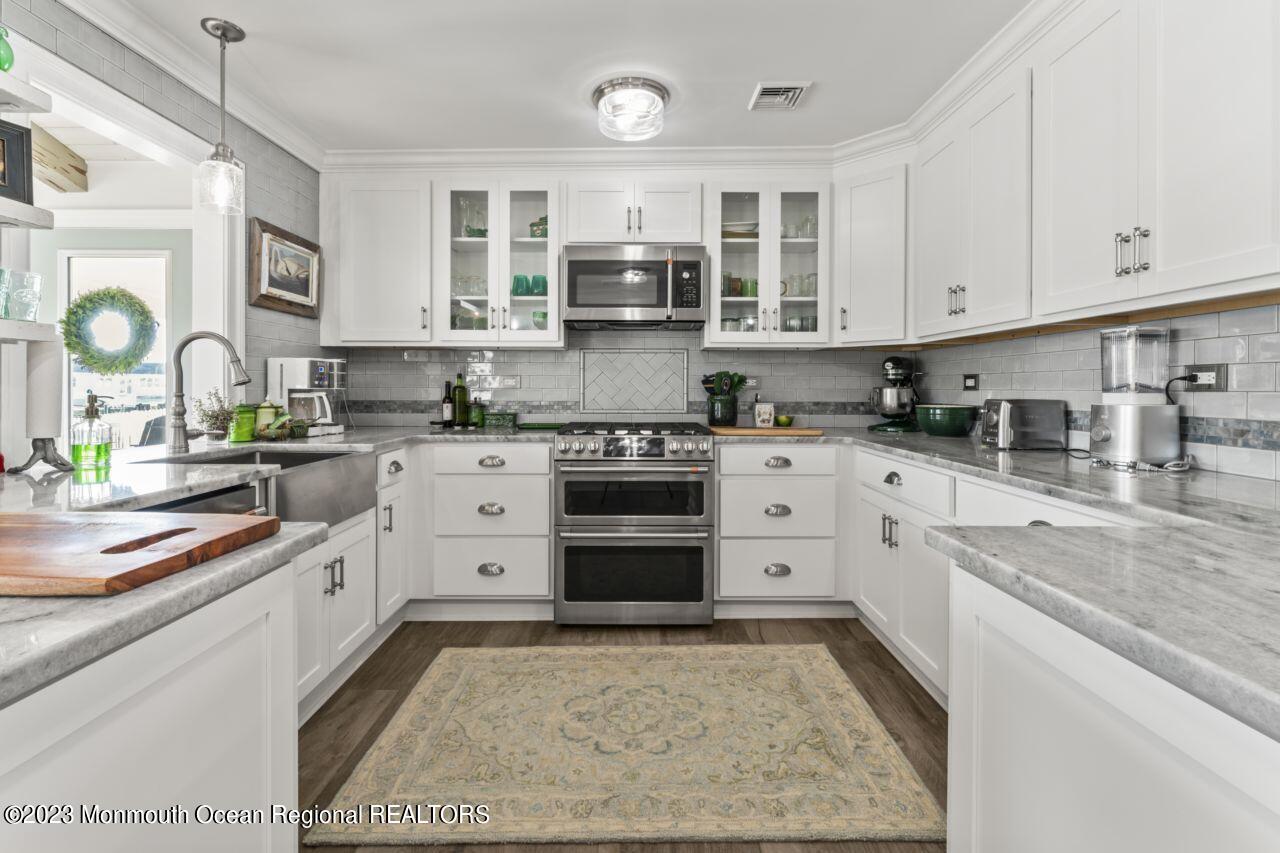 110 Stillwater Road Barnegat, NJ 08005 - Photo 13 of 35 a kitchen with stainless steel appliances granite countertop a stove and cabinets