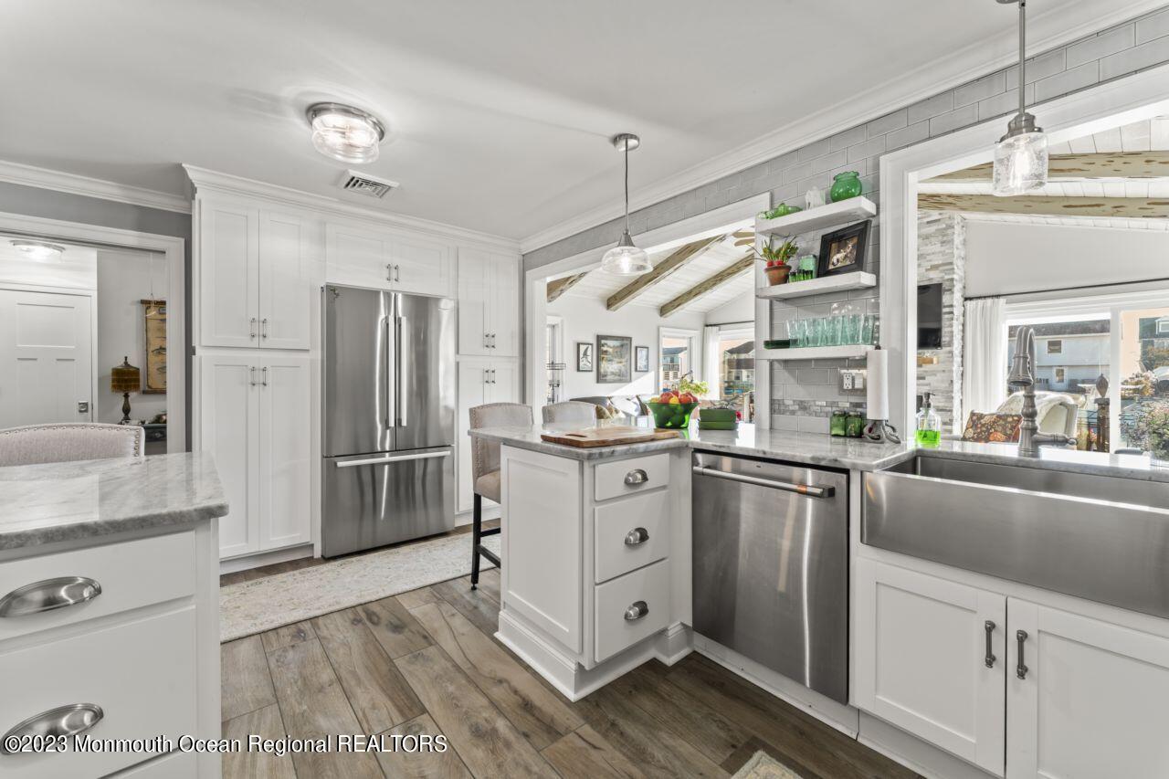 110 Stillwater Road Barnegat, NJ 08005 - Photo 16 of 35 a kitchen with white cabinets and stainless steel appliances