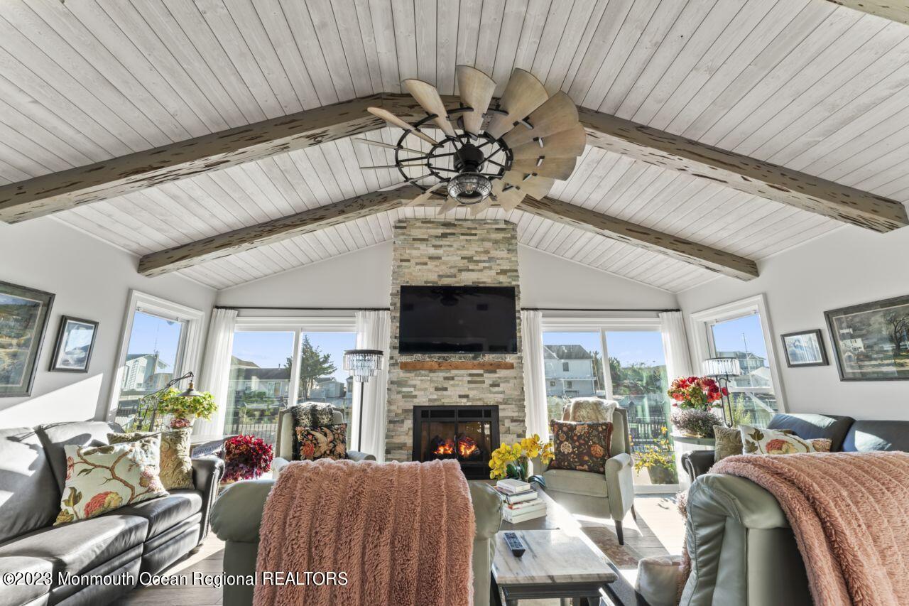 110 Stillwater Road Barnegat, NJ 08005 - Photo 21 of 35 a living room with furniture a fireplace and a chandelier