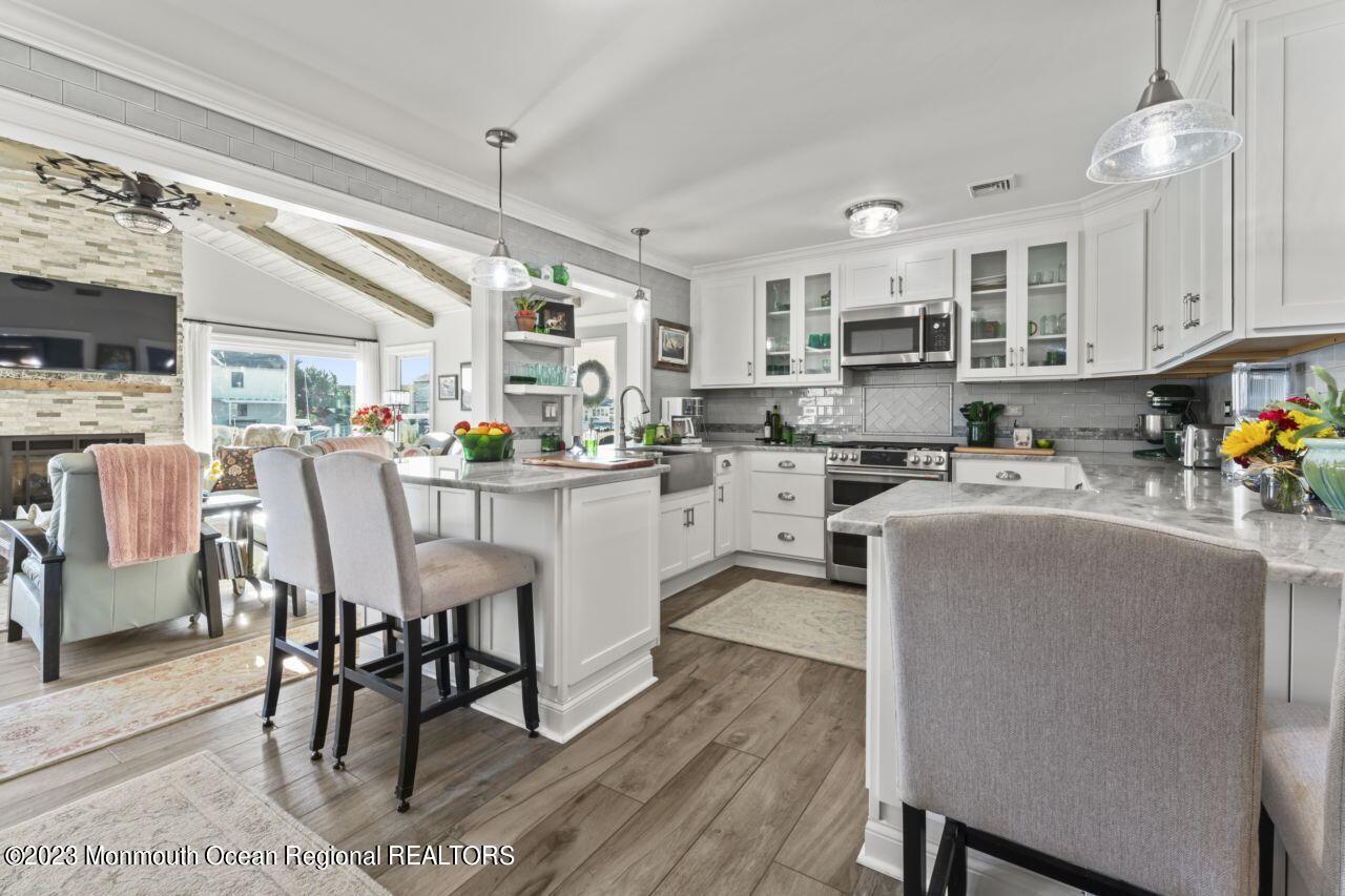 110 Stillwater Road Barnegat, NJ 08005 - Photo 22 of 35 a living room with stainless steel appliances kitchen island granite countertop furniture and a dining table