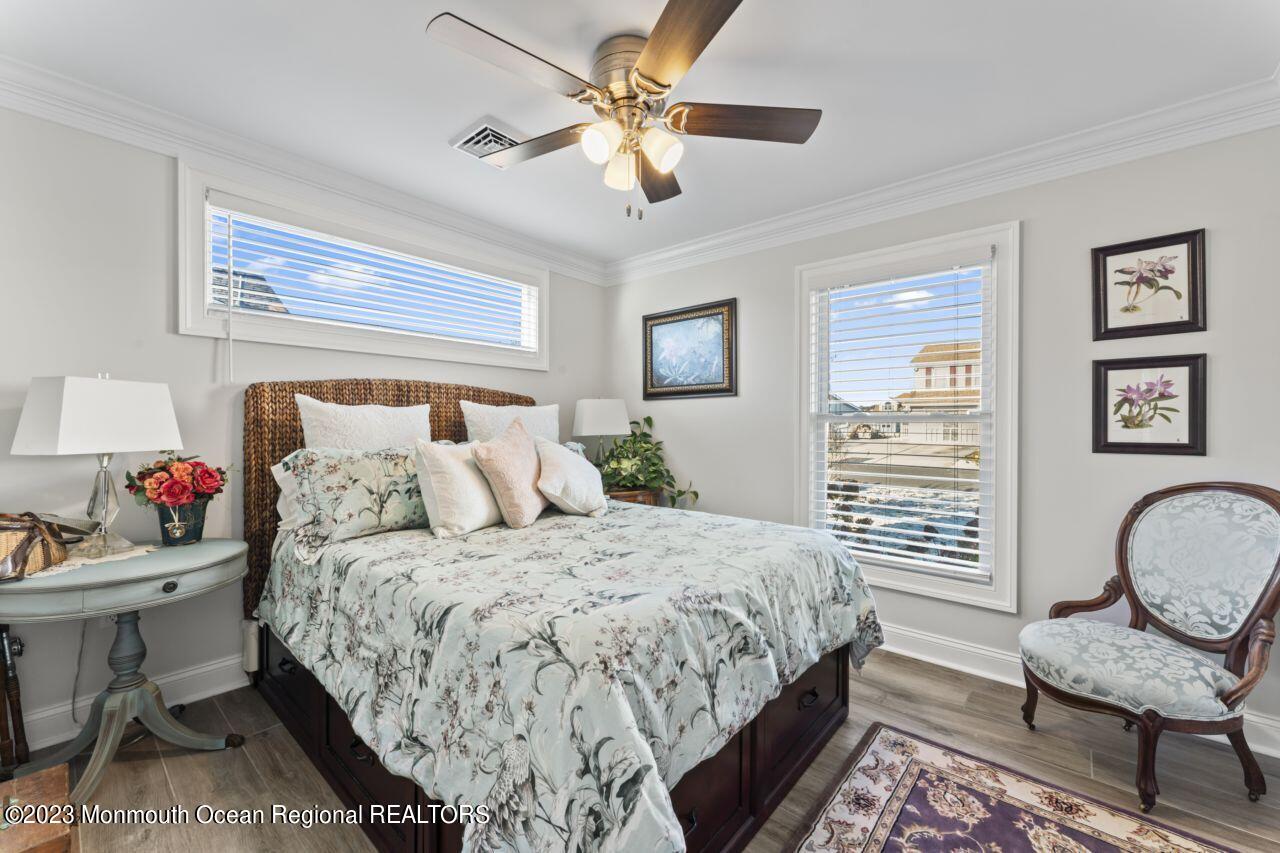 110 Stillwater Road Barnegat, NJ 08005 - Photo 26 of 35 a bedroom with a bed a chair and a chandelier