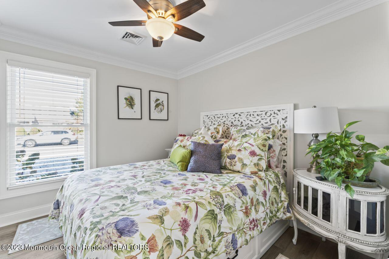 110 Stillwater Road Barnegat, NJ 08005 - Photo 27 of 35 a bedroom with a large bed and a chandelier